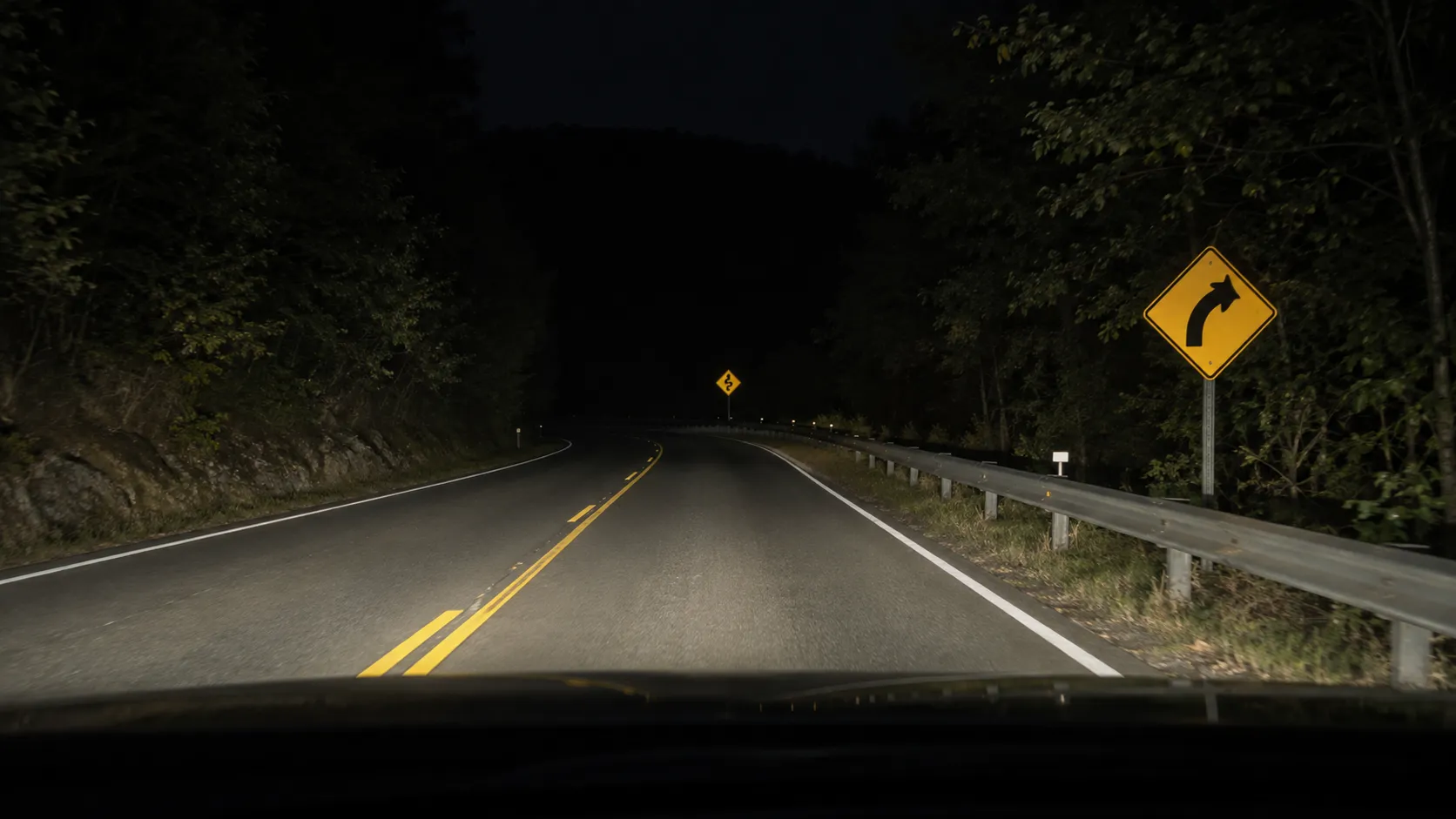 Reflective road signs viewed at different distances under vehicle headlights.webp