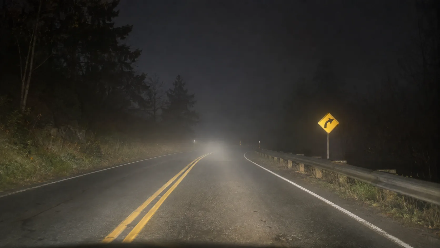 Reflective traffic sign visible through light fog at night.webp