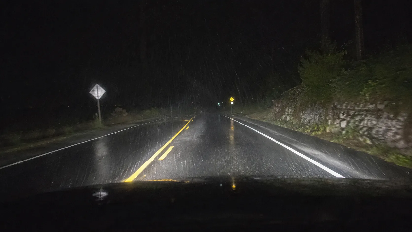 Reflective road signs during normal rainy nighttime driving.webp
