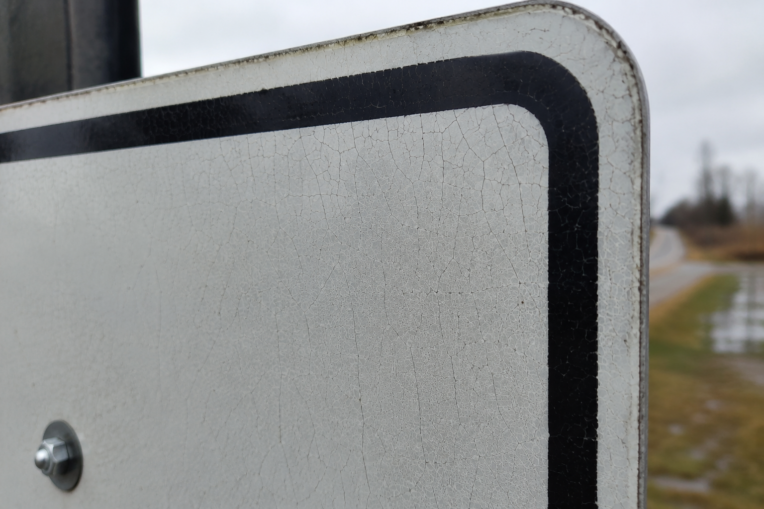 cracked-reflective-sheeting-on-outdoor-traffic-sign.png