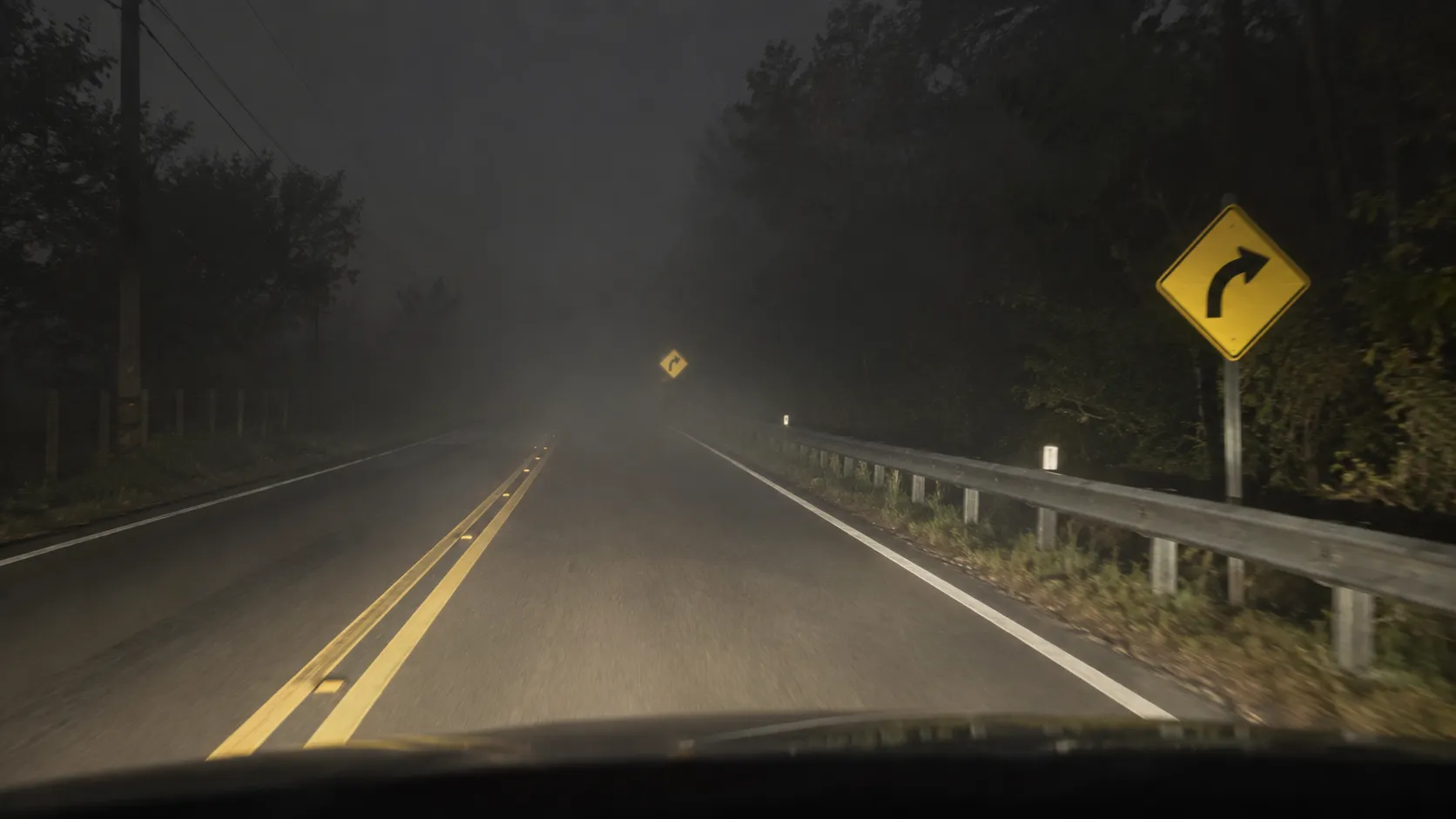 Reflective traffic signs at different distances in nighttime fog.webp